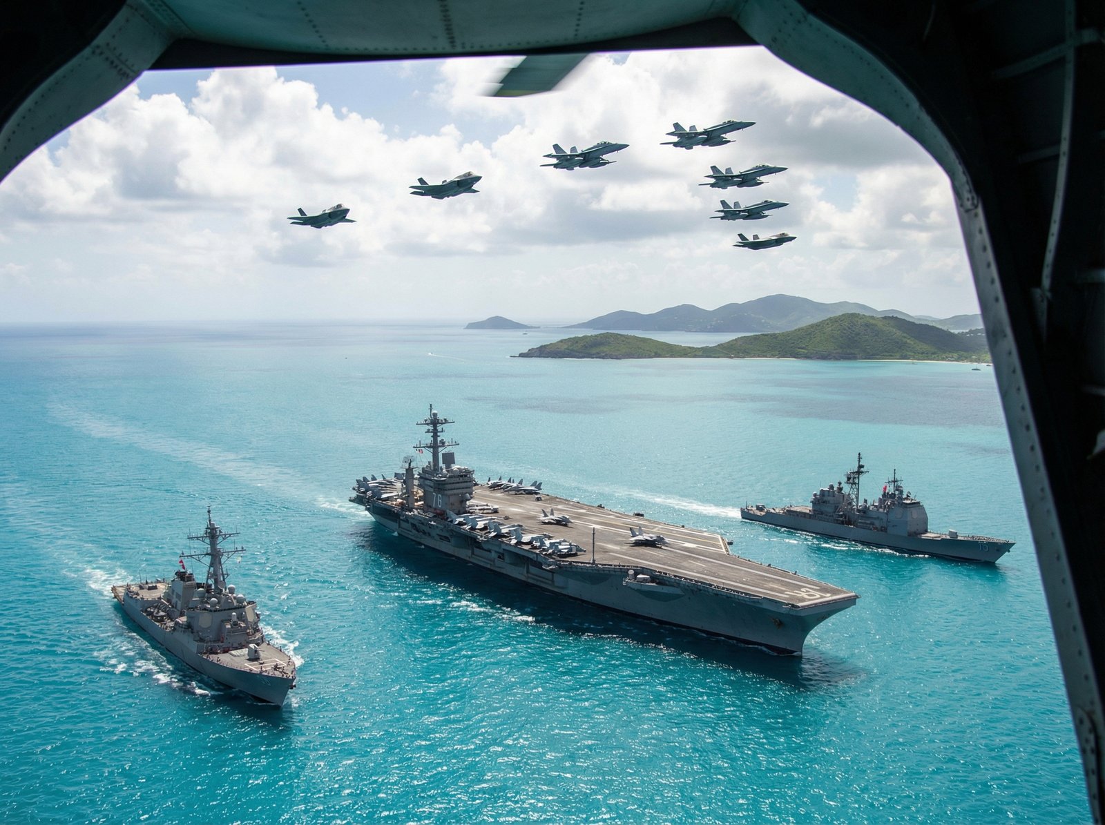 A US aircraft carrier sailing in the Caribbean Sea, flanked by warships and advanced fighter jets, indicating a significant military buildup in the region. Aspect ratio 4:3, no visible text, informational style.