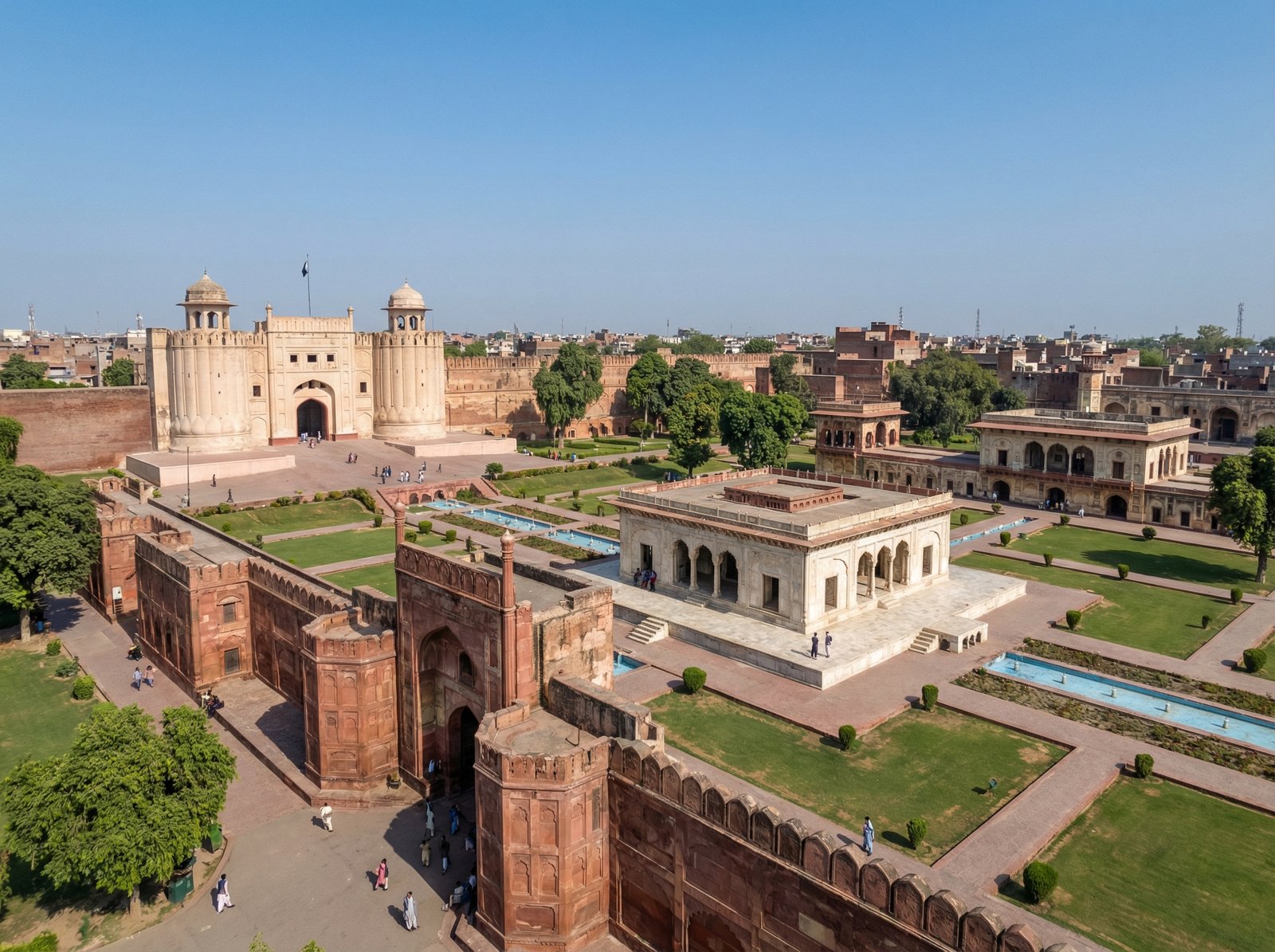 Panoramic view of the historic Fort and Shalamar Gardens in Lahore, Pakistan, showcasing their grand scale and intricate architecture under a clear sky. informational style, no visible text, aspect ratio 4:3