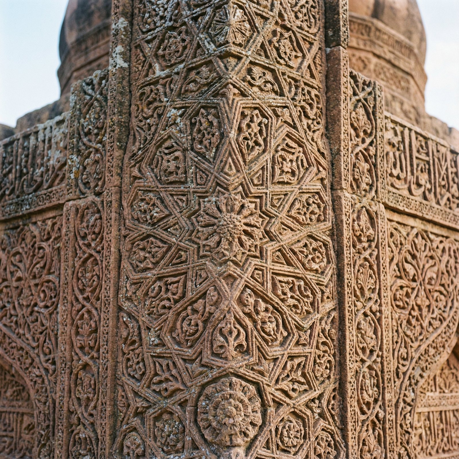 Close-up of a intricately carved stone tomb at Makli Hill, showing detailed geometric patterns and floral motifs, characteristic of Islamic funerary architecture. Aspect ratio 1:1, no visible text.
