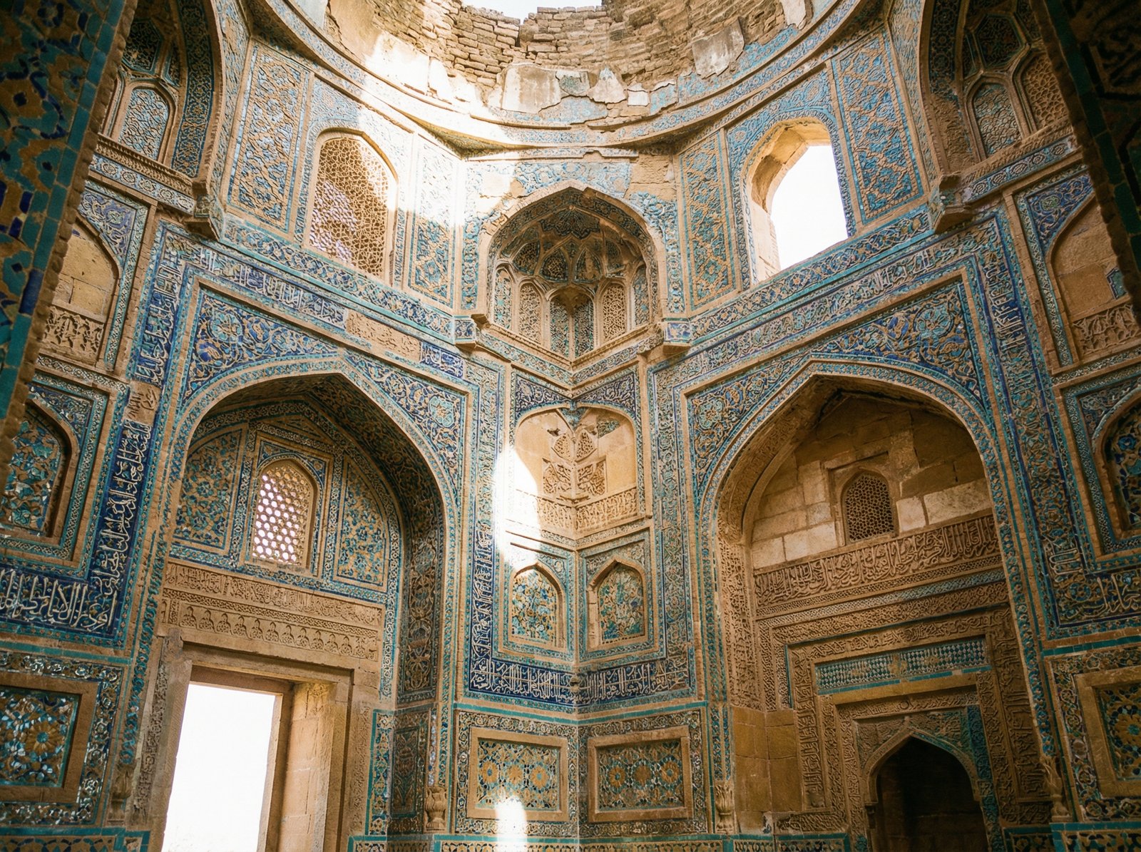 Interior view of an ancient tomb at Makli Hill with a distinctive dome and archway, showing the intricate tile work and decorative elements inside. Aspect ratio 4:3, no visible text.