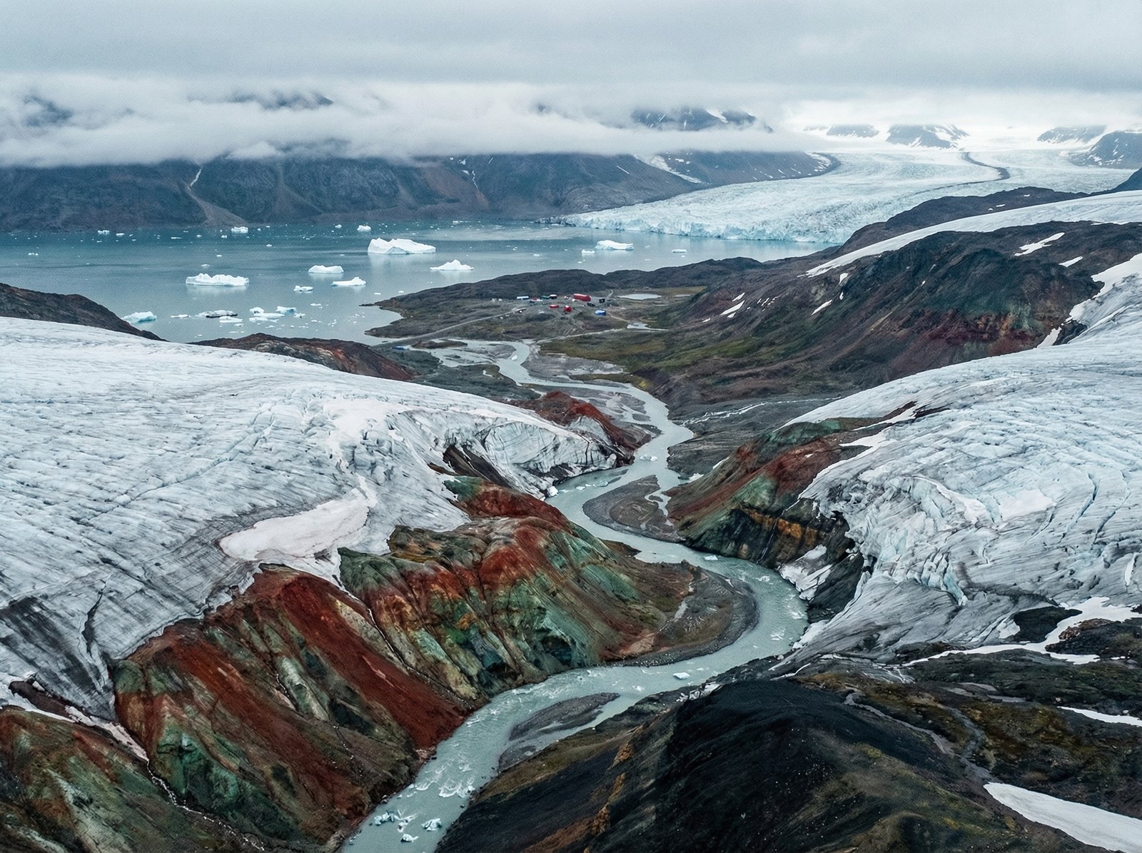 Vast Arctic landscape of Greenland, melting glaciers, rich mineral textures visible, majestic and cold atmosphere, cinematic wide shot, realistic photography, 4:3