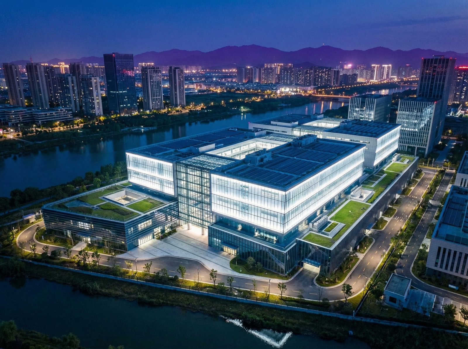 A modern, high-tech semiconductor fabrication plant (fab) in Nanjing, China at night, with bright, clean lighting illuminating the exterior. No visible text. Aspect ratio 4:3.