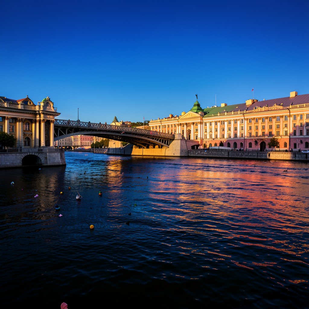 Saint Petersburg Neva river and Lieutenant Schmidt Bridge with historic architecture, warm sunlight, deep blue sky, aspect ratio 4:3