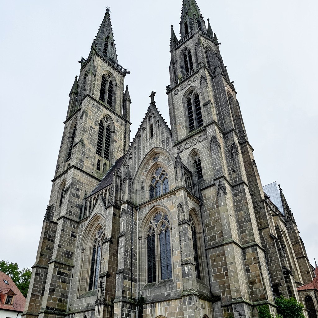 Exterior of a historic Gothic church in Wittenberg Germany with tall tower and stone facade, no visible text, no logos, no watermark, aspect ratio 4:3