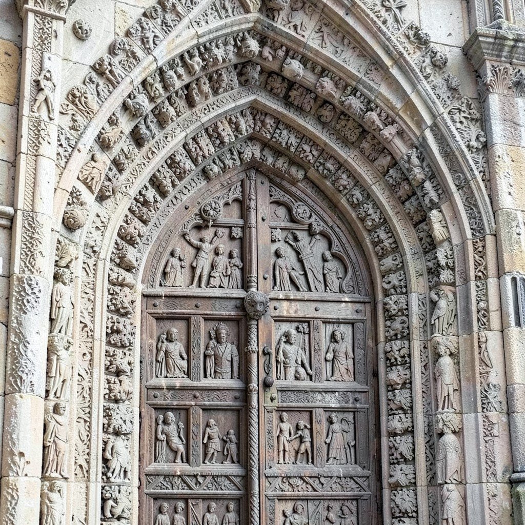 Detailed close-up of intricate medieval Romanesque stone carved portal of St Lovro Cathedral in Trogir historic architecture no visible text no logos no watermark aspect ratio 1:1
